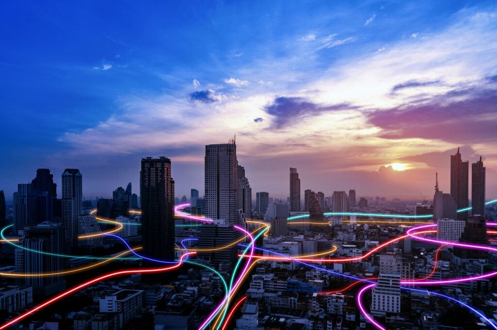 Modern city skyline with intersecting neon lines representing field service delivery powered by technology.